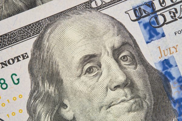 Portrait of Franklin on a hundred dollar bill. Close-up of one hundred US dollars banknotes, selective focus. Business finance concept, business news splash screen, banner mockup